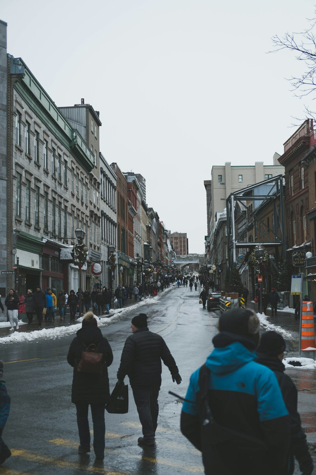 Cobblestone street lined with historic stone buildings in Old Quebec City